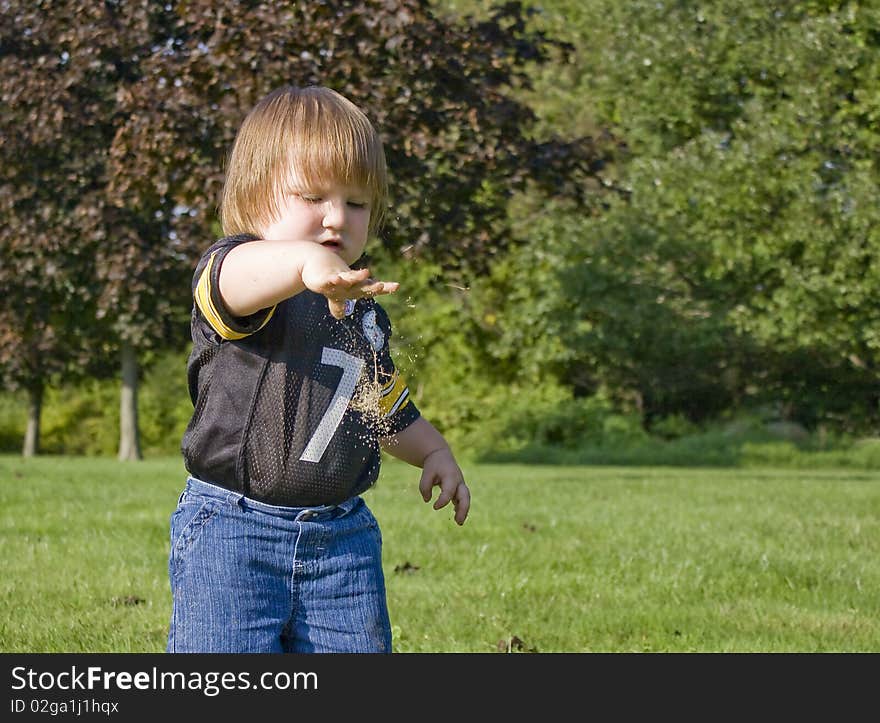 Child dropping a pile of dirt. Child dropping a pile of dirt