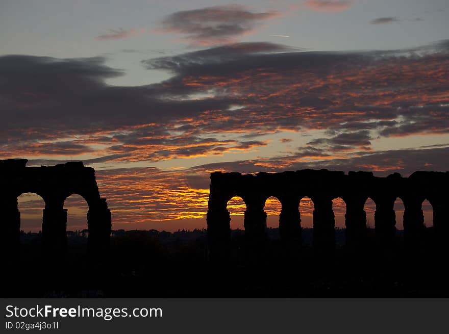 Sunset on ancient roman aqueduct