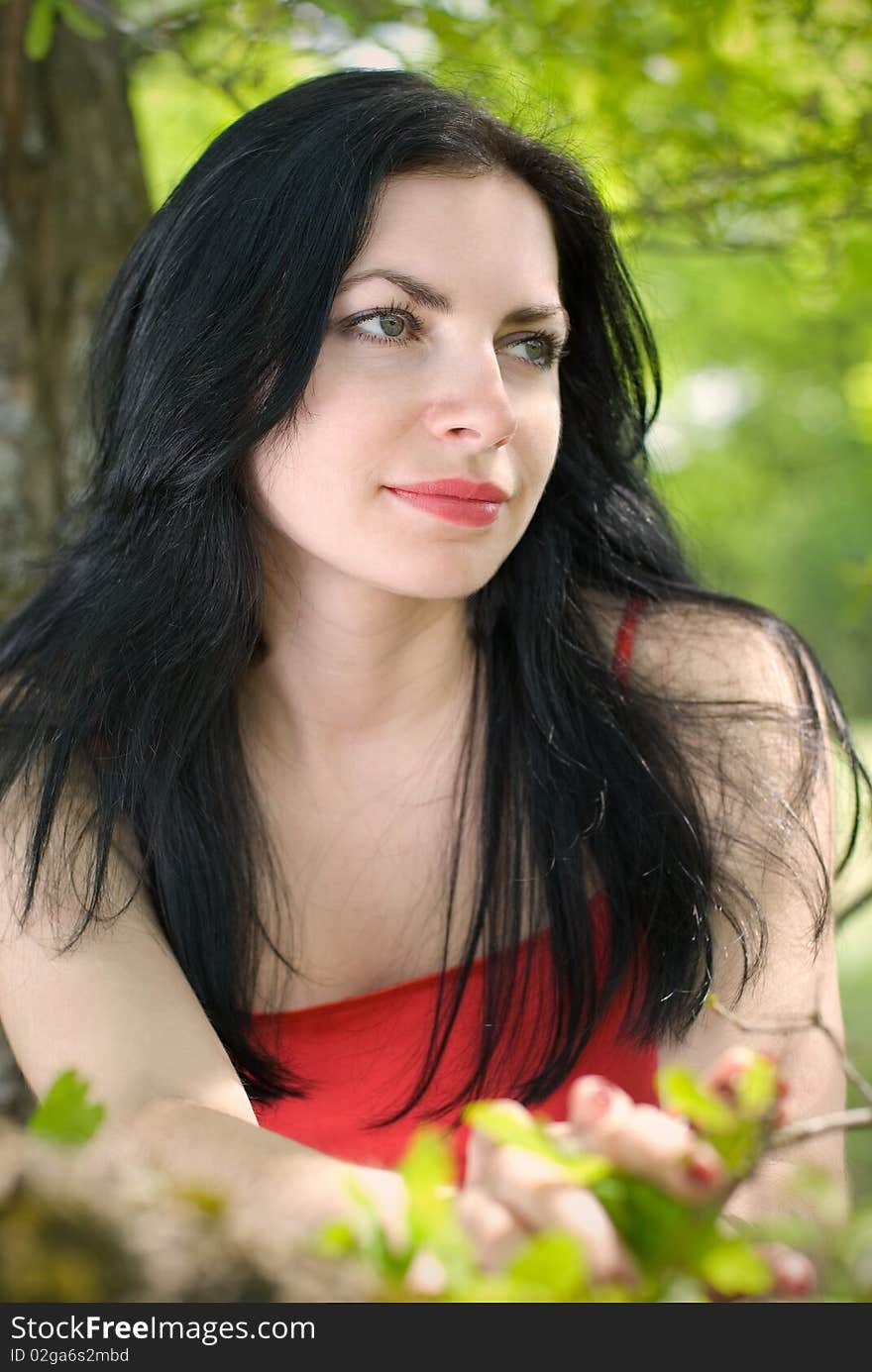 Portrait of the young woman in forest.