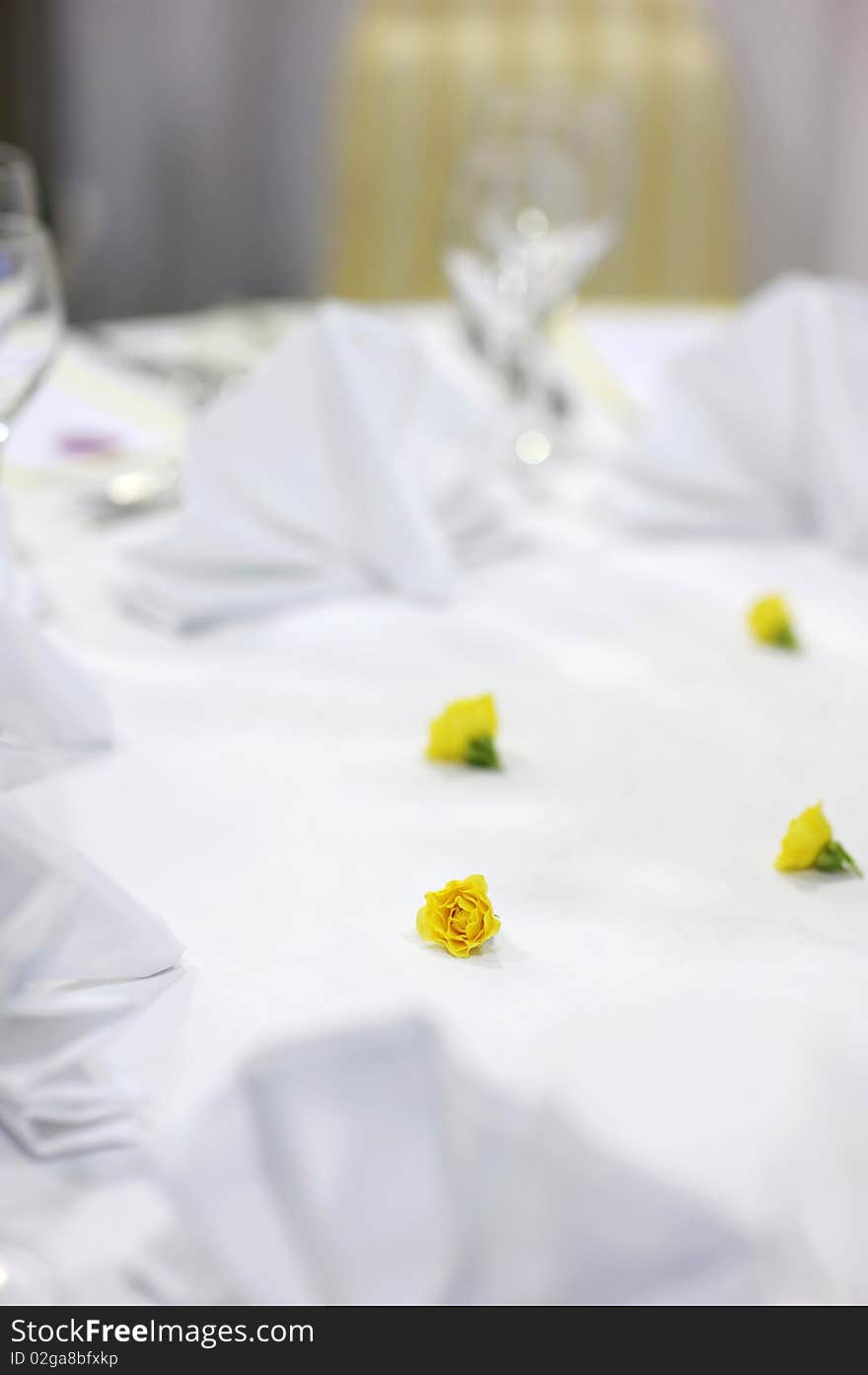 Small yellow flowers decoration on a festive table