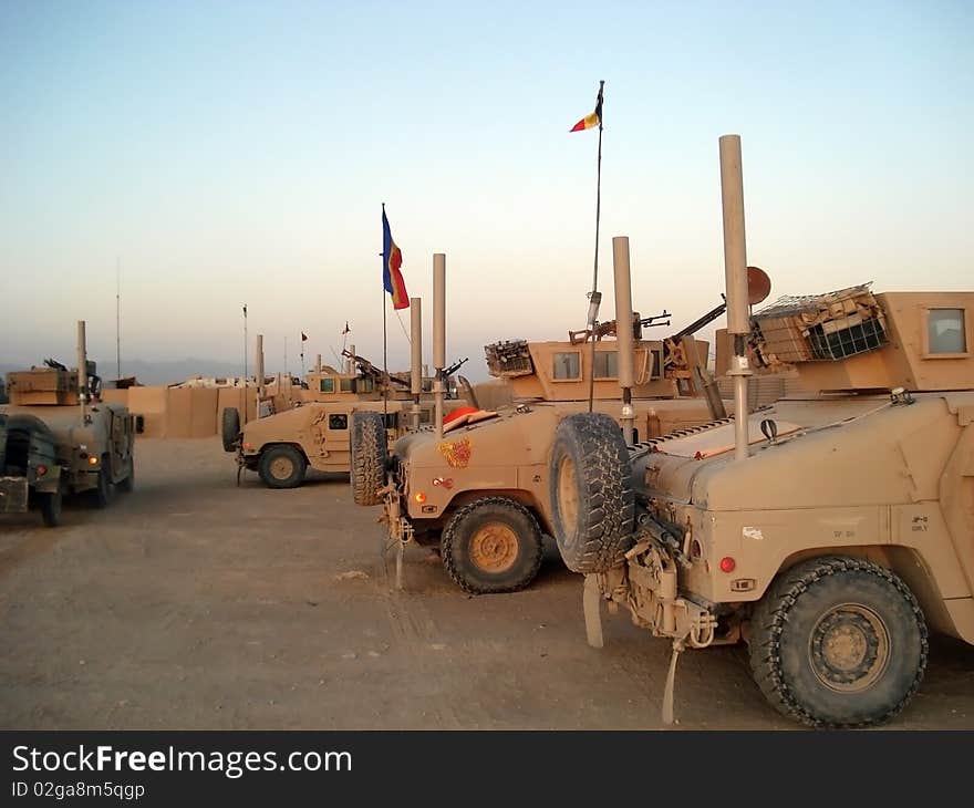 This is a picture with many Humvee trucks parked for the night. This is a picture with many Humvee trucks parked for the night