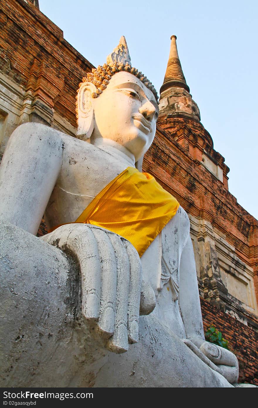 The ancient Buddha statue in front of the pagoda, Ayutthaya, Thailand. The ancient Buddha statue in front of the pagoda, Ayutthaya, Thailand