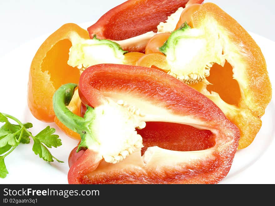 Red and yellow pepper halves on a white plate