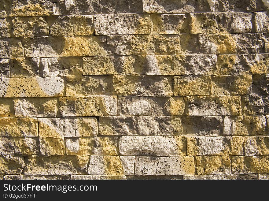 Detail of yellow graffiti over a brick wall. Detail of yellow graffiti over a brick wall.