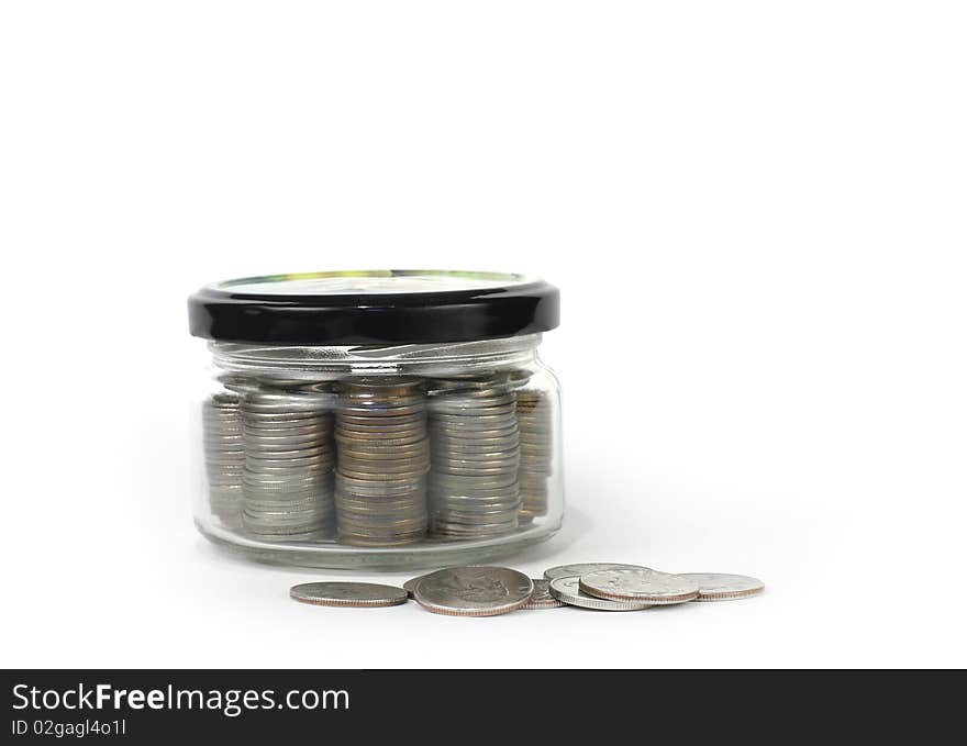 Glass jar with lid closed money on a light background. Glass jar with lid closed money on a light background