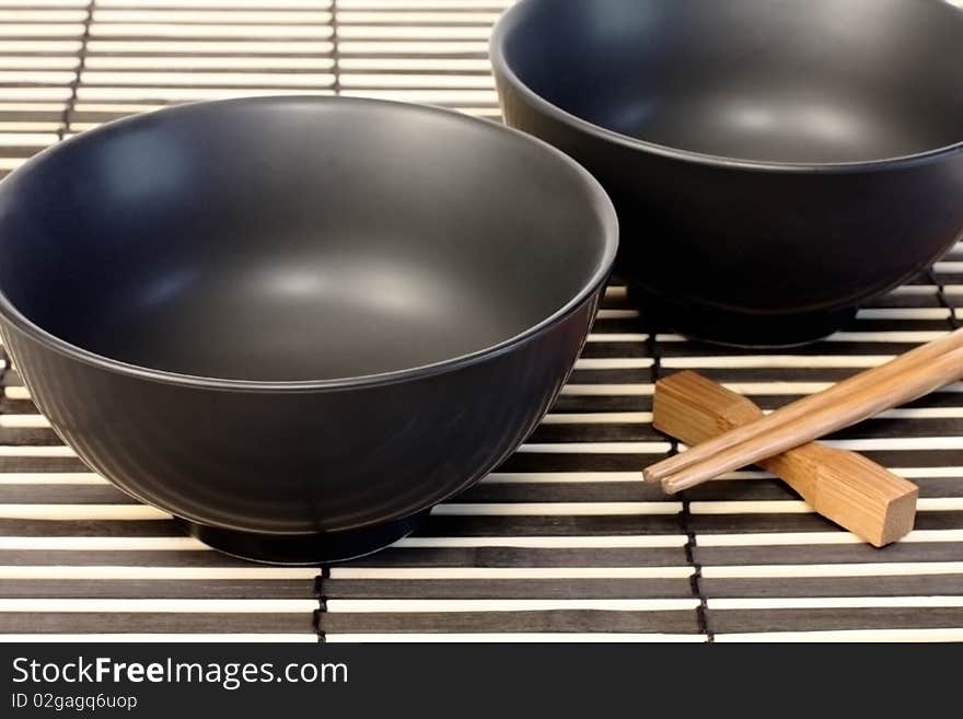 Black bowls and wooden chopsticks for sushi. Black bowls and wooden chopsticks for sushi