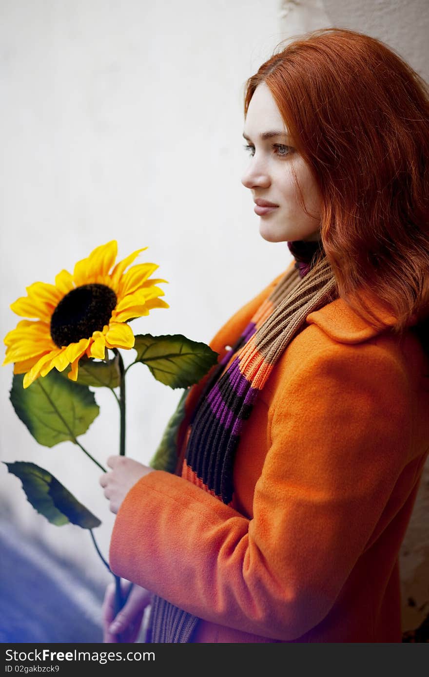 Pretty girl walking with a sunflower city