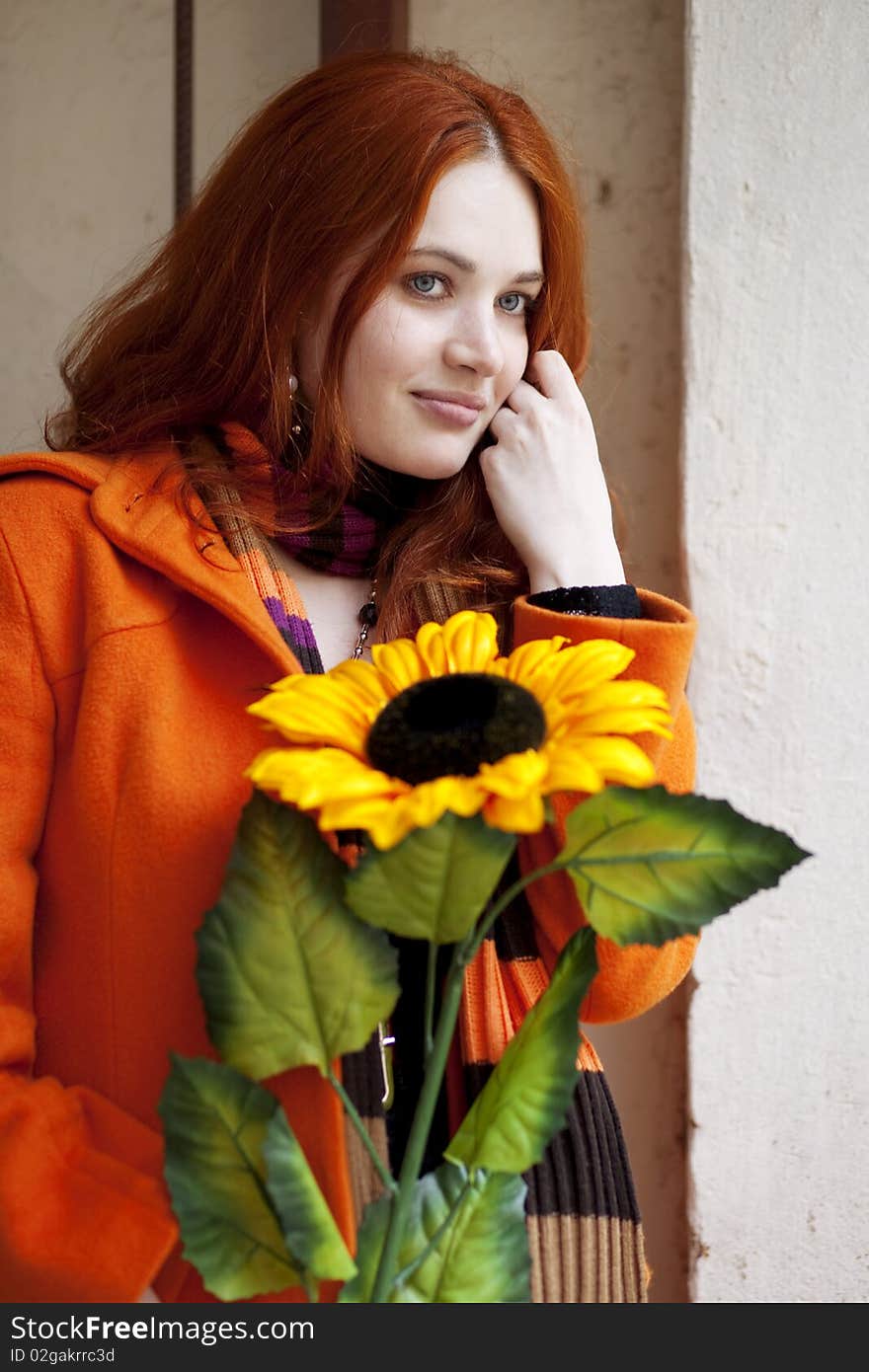 The image of a pretty girl walking with a sunflower city