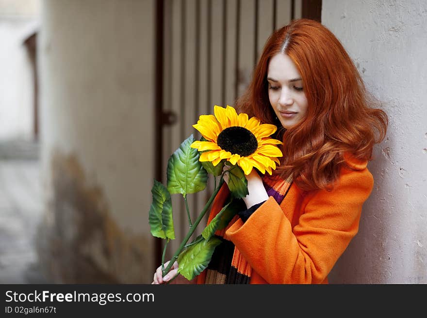 The image of a pretty girl walking with a sunflower city