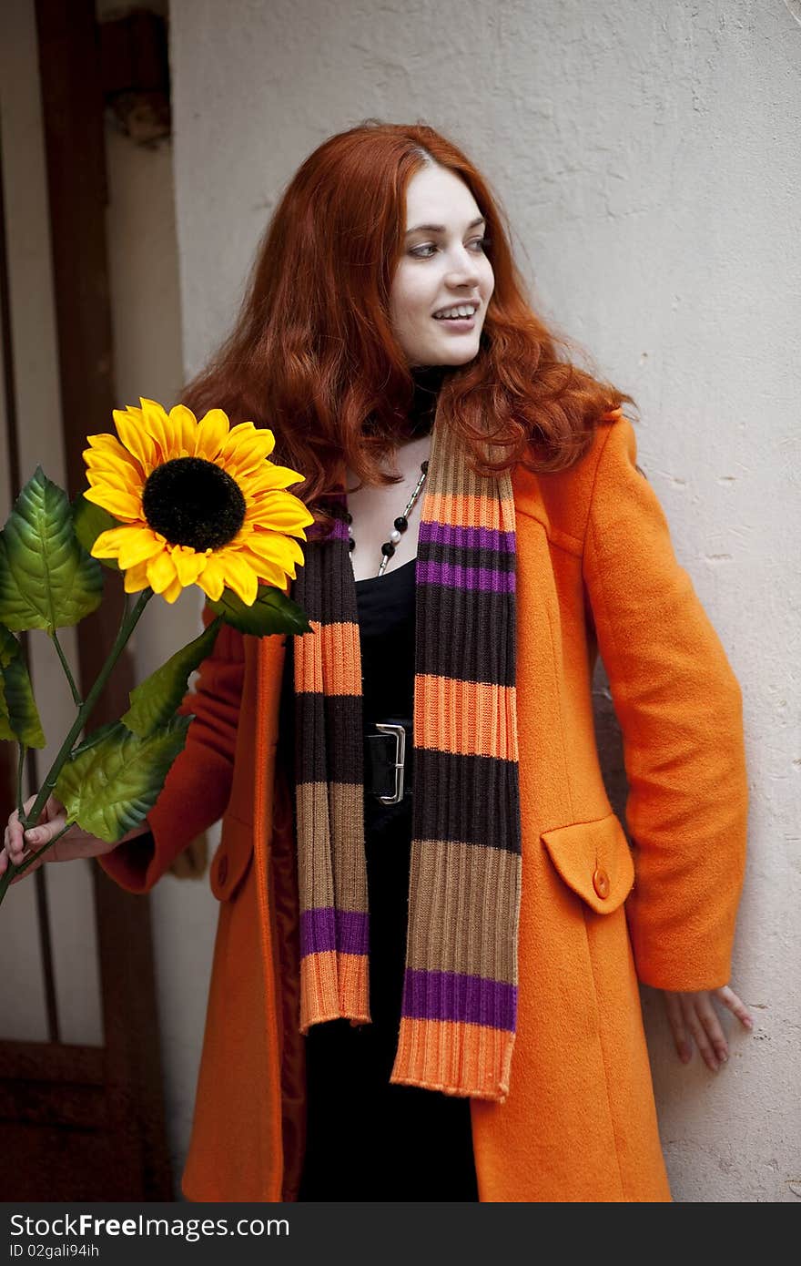 Pretty girl walking with a sunflower city