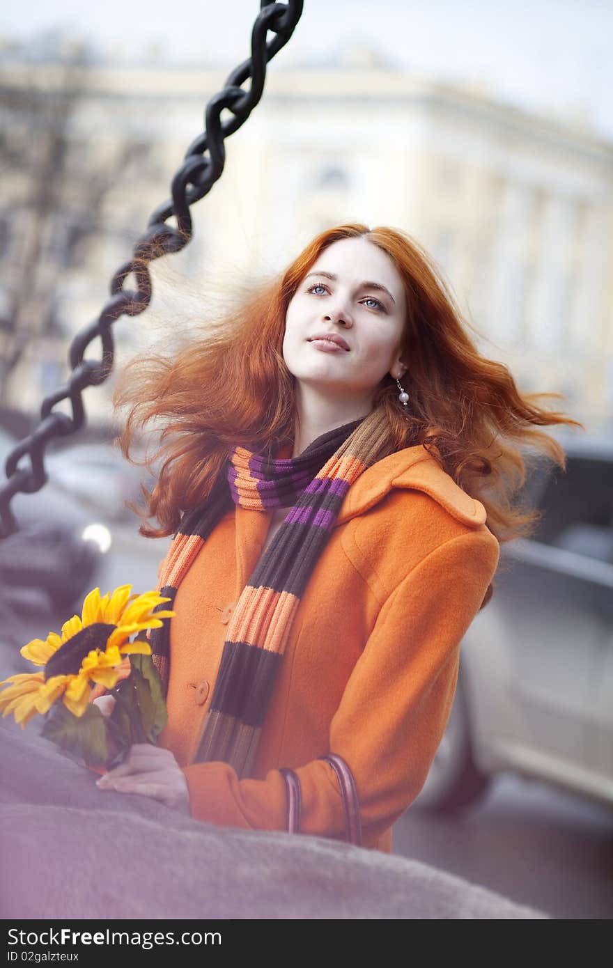 The image of a pretty girl walking with a sunflower city