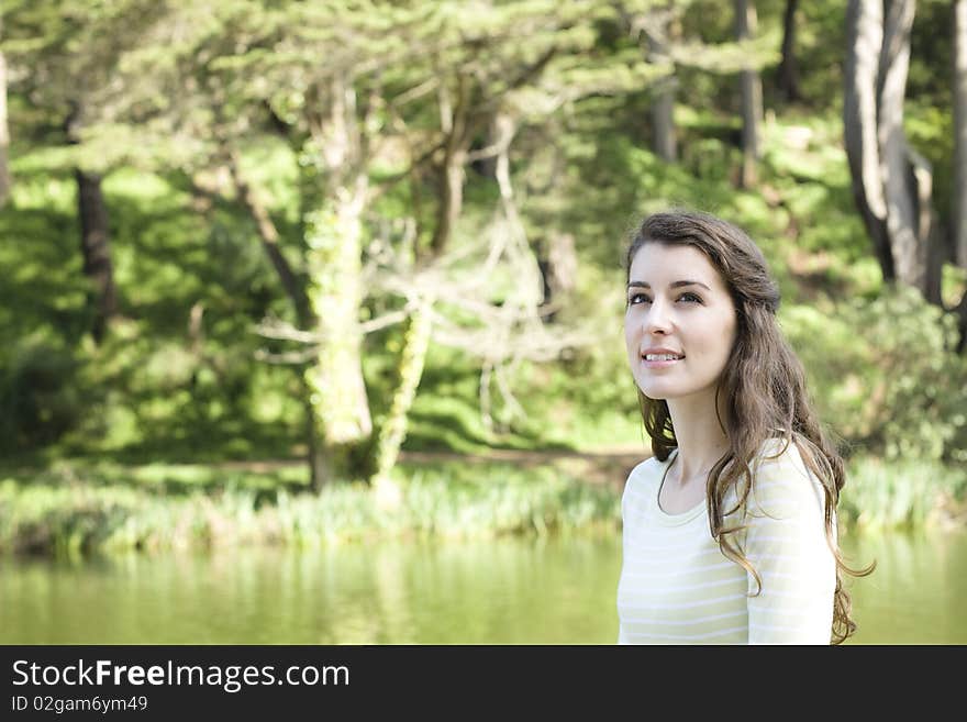 Portrait of a Pretty Young Woman Looking Up To The Sky in a Park. Portrait of a Pretty Young Woman Looking Up To The Sky in a Park