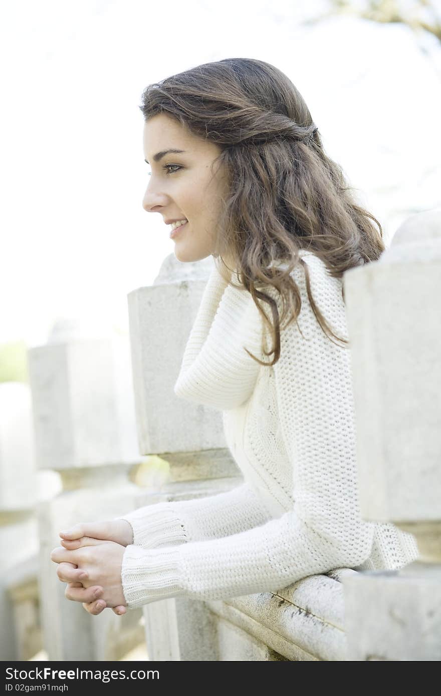 Profile of a Beautiful Young Woman Leaning on a Railing. Profile of a Beautiful Young Woman Leaning on a Railing