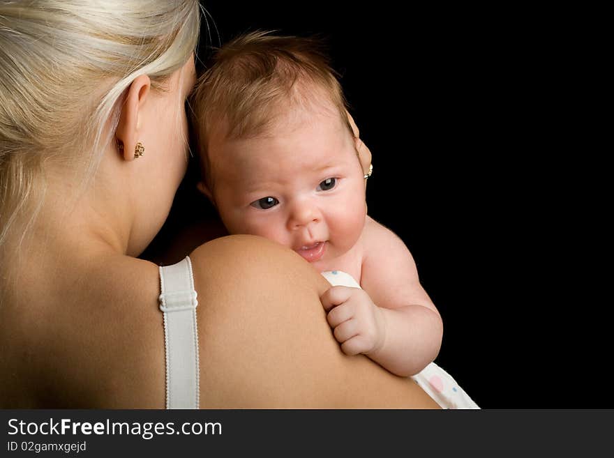 Infant smiling on the mother shoulder. Infant smiling on the mother shoulder