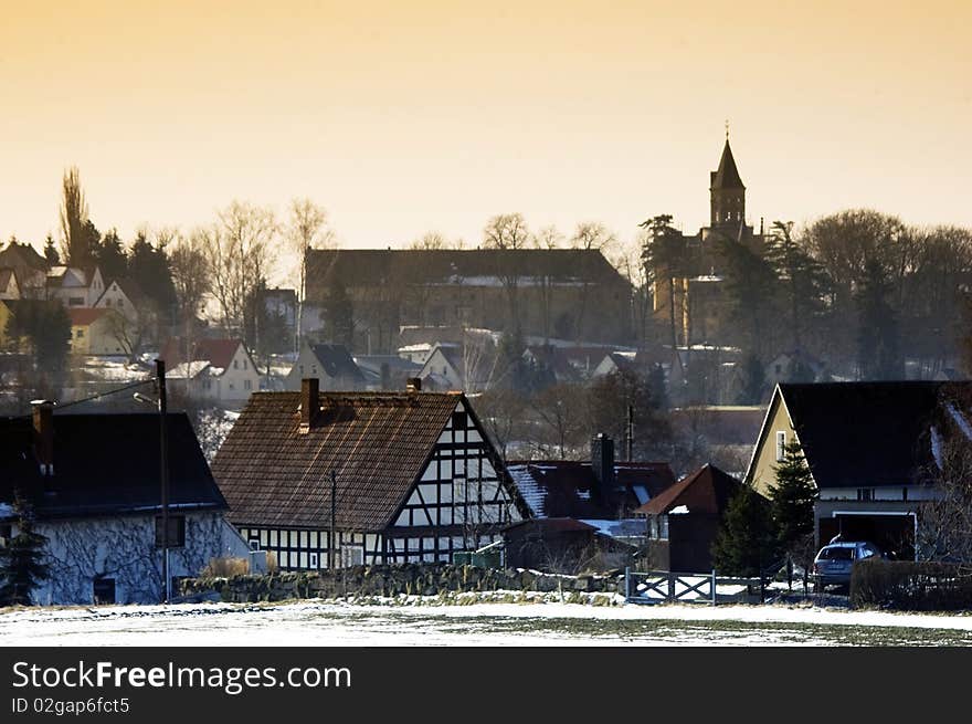 View of a snow village with church in winter