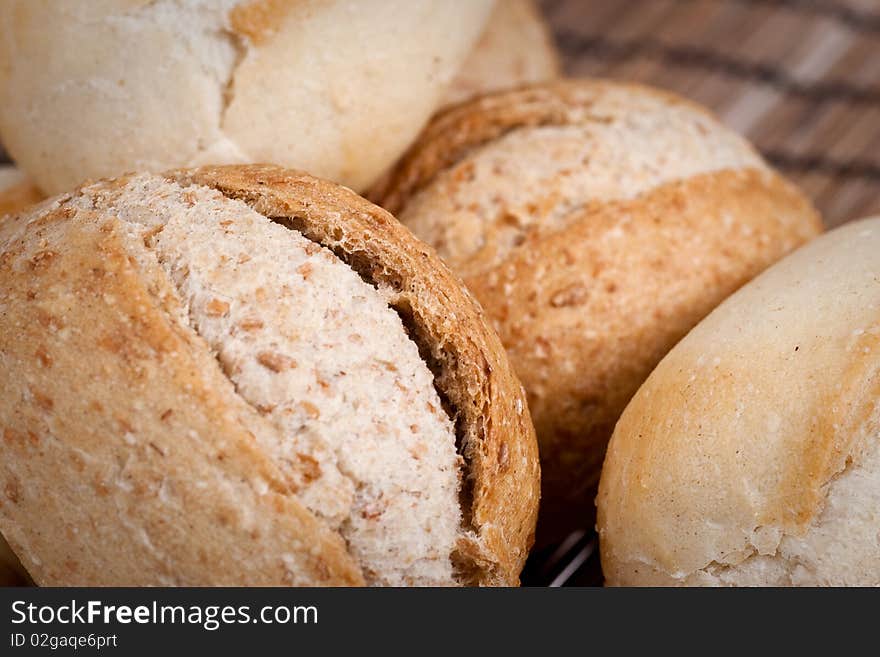 Rye and wheat french bread, baked in a wood oven. Selective focus. Extreme closeup. Rye and wheat french bread, baked in a wood oven. Selective focus. Extreme closeup.