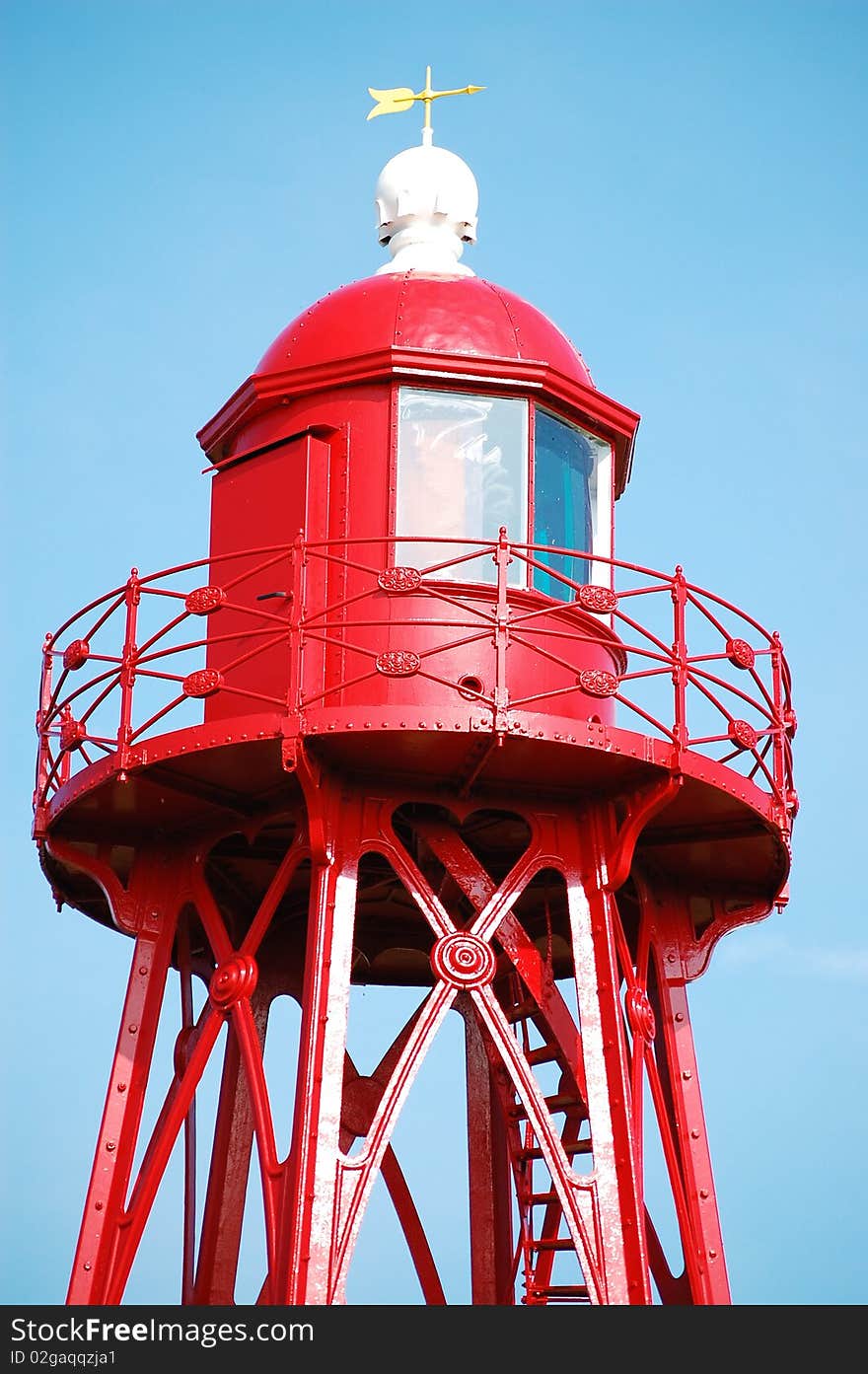 The lighthouse of Den Oever in The Netherlands in bright sunlight. The lighthouse of Den Oever in The Netherlands in bright sunlight.