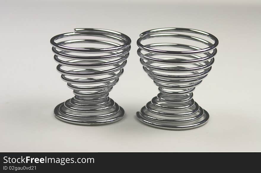 Two spiral metal egg cups empty and waiting for an egg