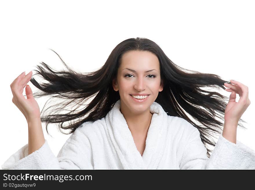 Smiling girl in bathrobe flinging long black hair. Smiling girl in bathrobe flinging long black hair.