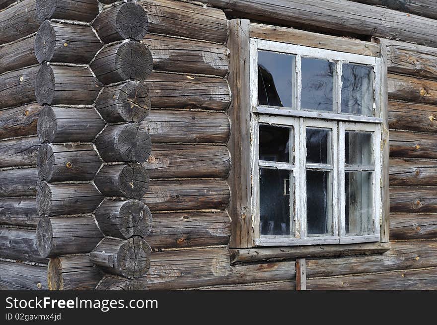 Fragment of old wooden house wall with window. Fragment of old wooden house wall with window