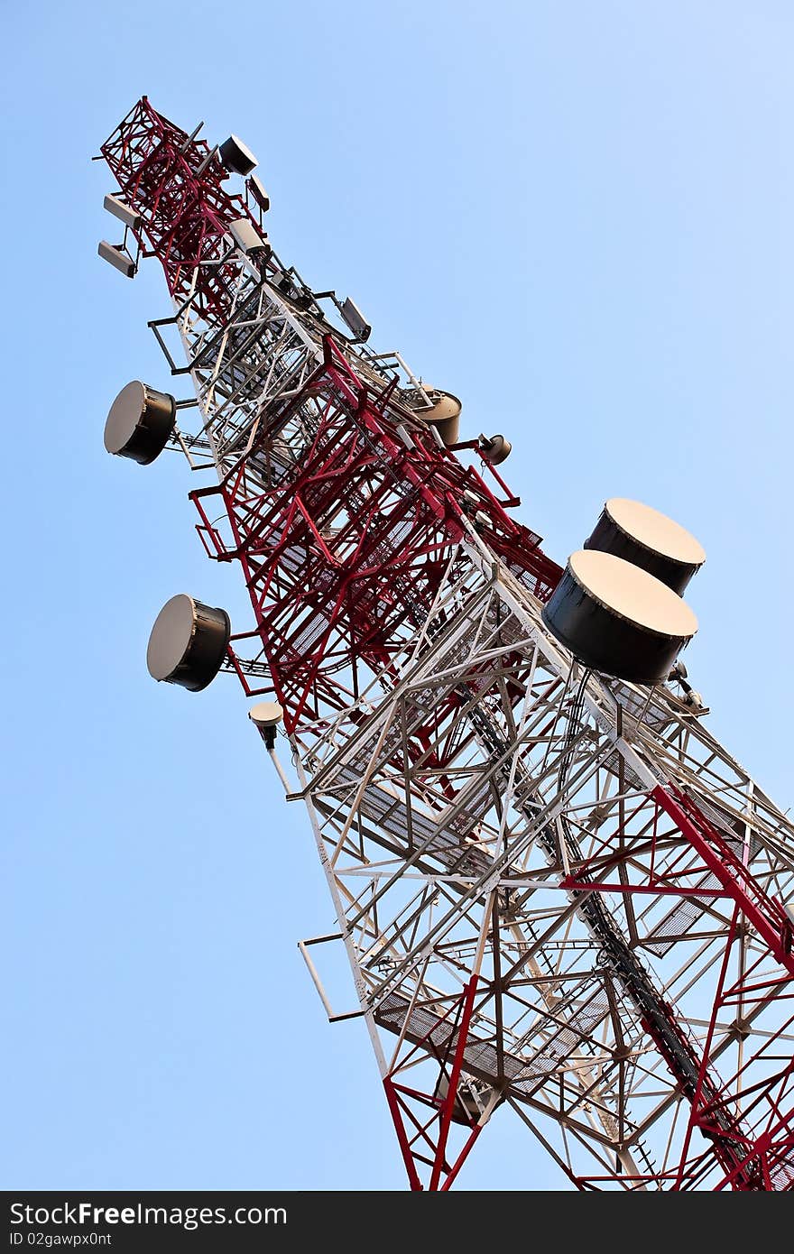 Telecommunication tower with antennas over blue sky. Telecommunication tower with antennas over blue sky.