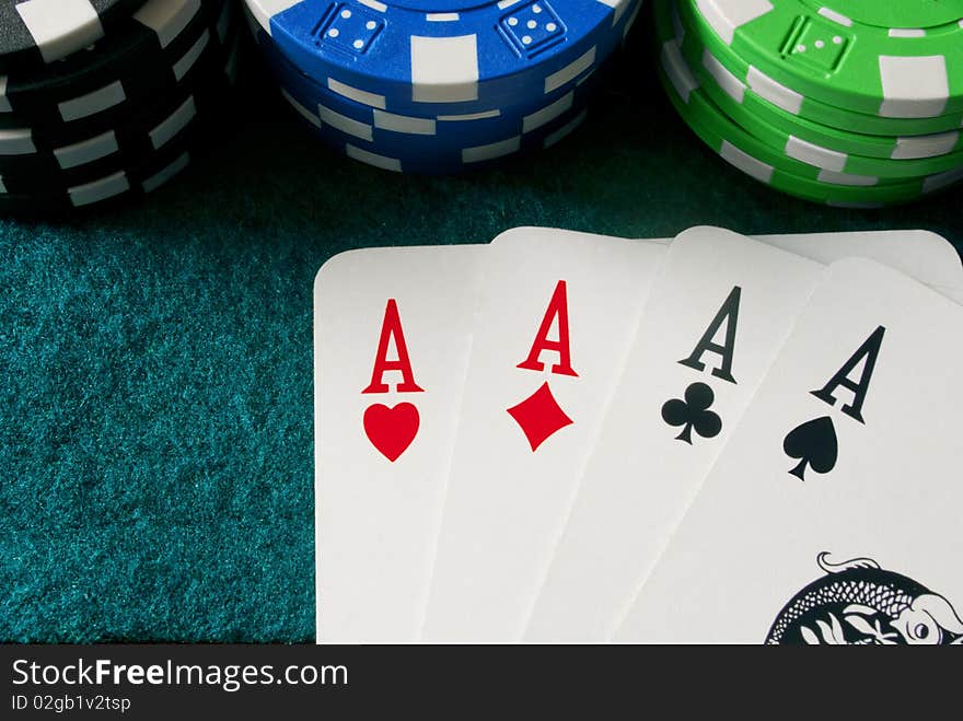 Chips and a poker of aces on a gambling table