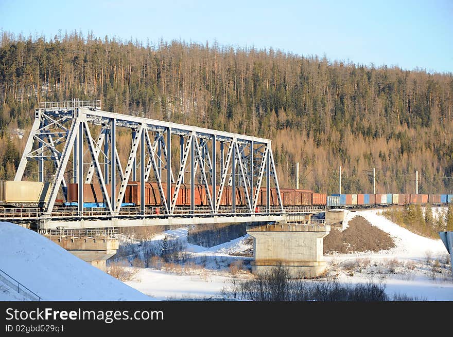 Cargo train going through the bridge. Cargo train going through the bridge