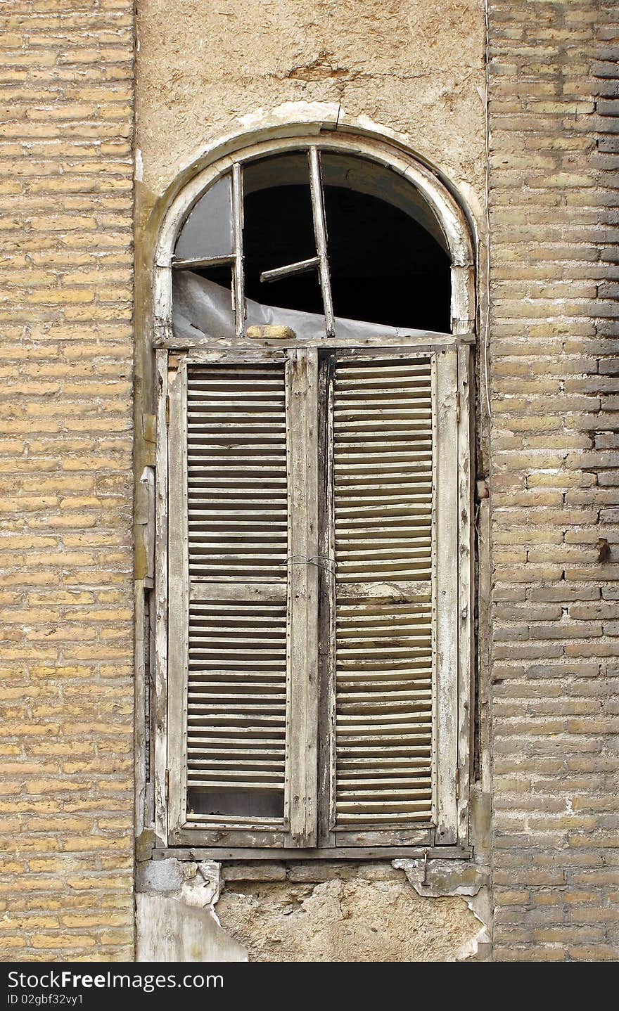 Wooden window shutter of an old abandoned house. Wooden window shutter of an old abandoned house