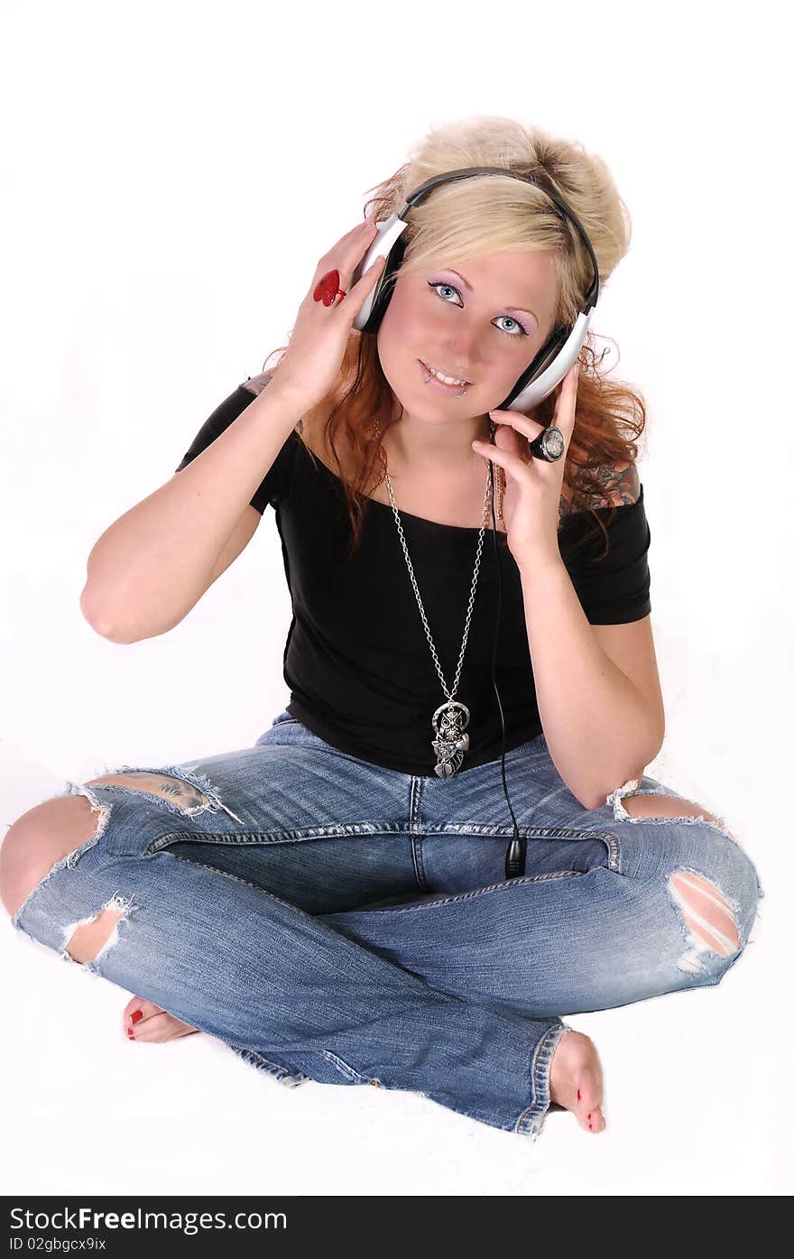 A isolated picture of a woman listening to music. A isolated picture of a woman listening to music