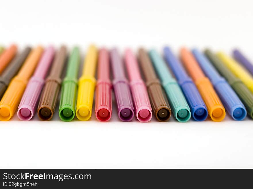 Front view of row of colorful markers with shallow dof