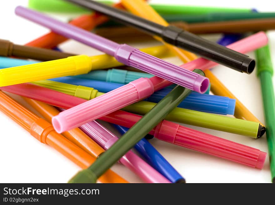 Pile of colorful markers on white background with shallow dof. Pile of colorful markers on white background with shallow dof