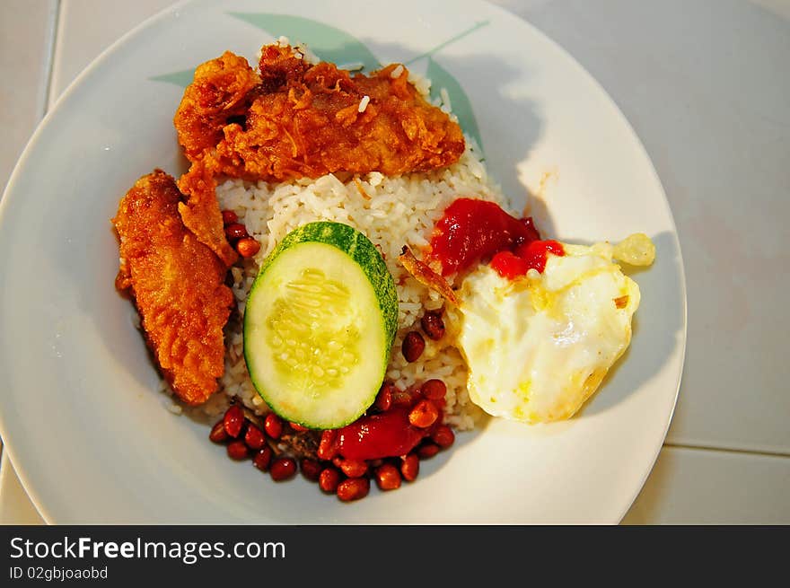 Fried chicken wing, rice, cucumber and eggs