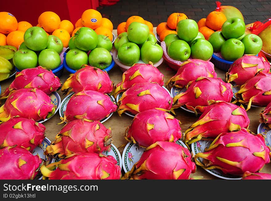 Apple, orange and dragon fruits