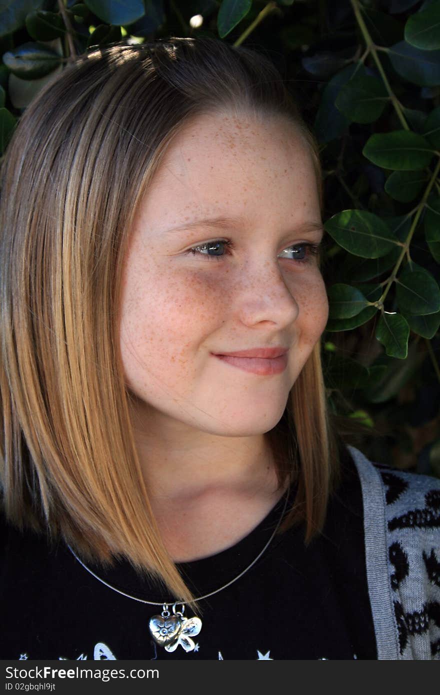 A beautiful white caucasian girl child with a happy expression on her face