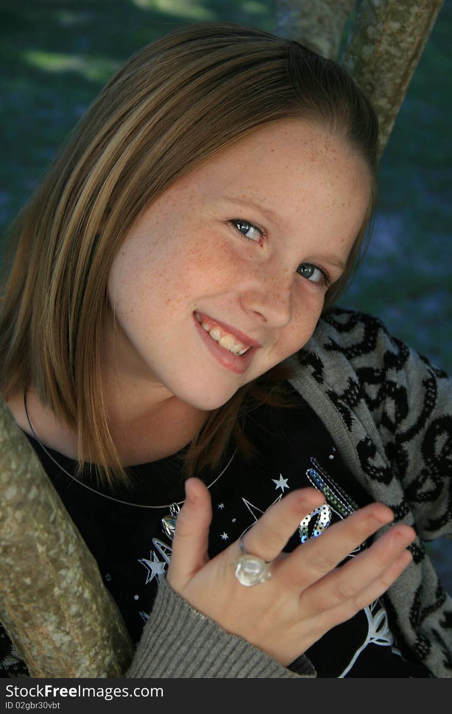 A beautiful white caucasian girl child with a happy expression on her face holding out her hand. A beautiful white caucasian girl child with a happy expression on her face holding out her hand