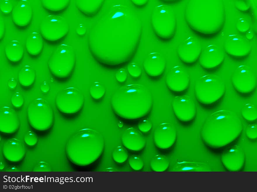 Water drops on a green surface