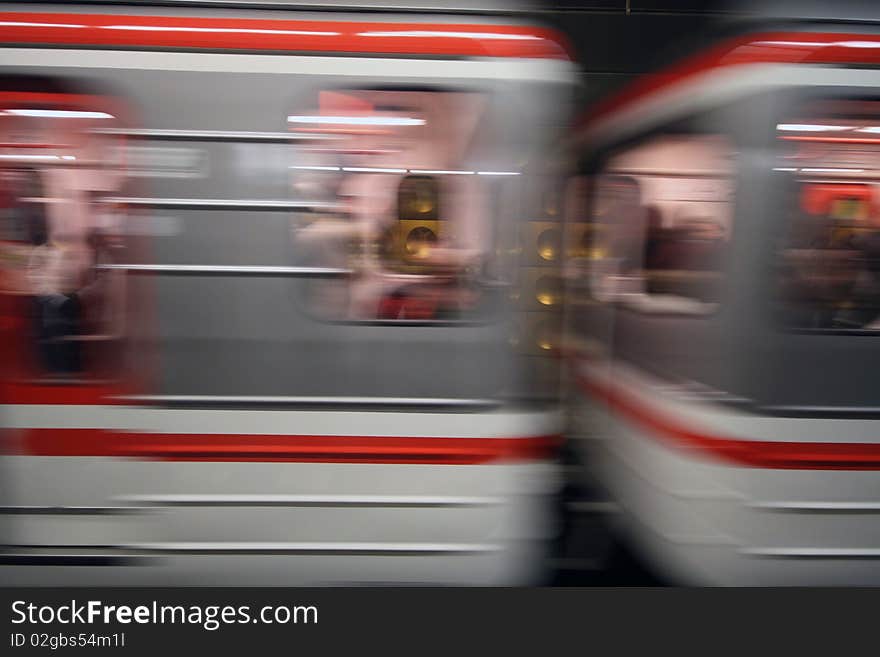 Blurred subway cars rushing through tunnel