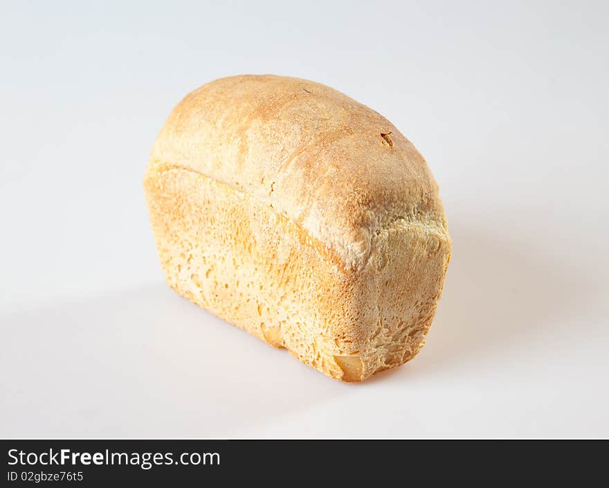 Loaf of bread with grains on a white background