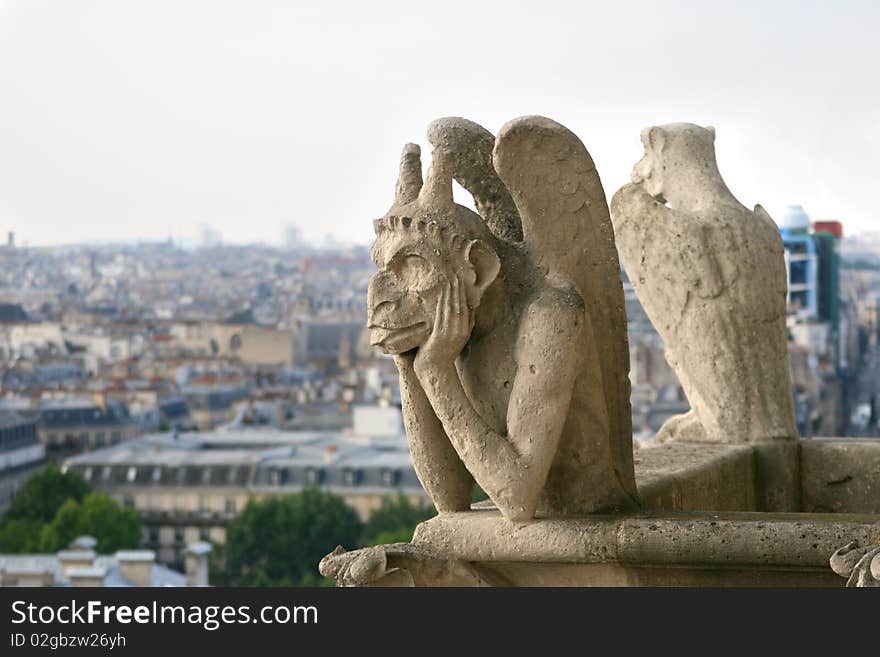 Chimera in gothic style is watching over Paris from top of Notre Dame cathedral. Chimera in gothic style is watching over Paris from top of Notre Dame cathedral.