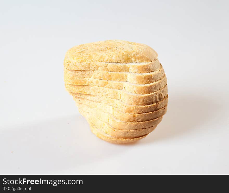 Loaf of bread with grains on a white background