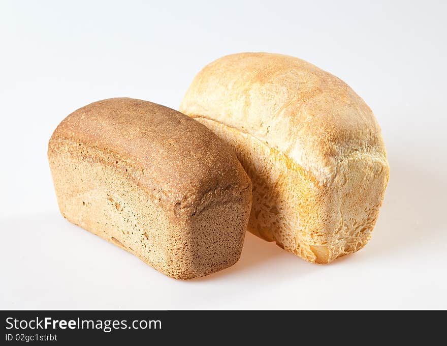 Loaf of bread with grains on a white background