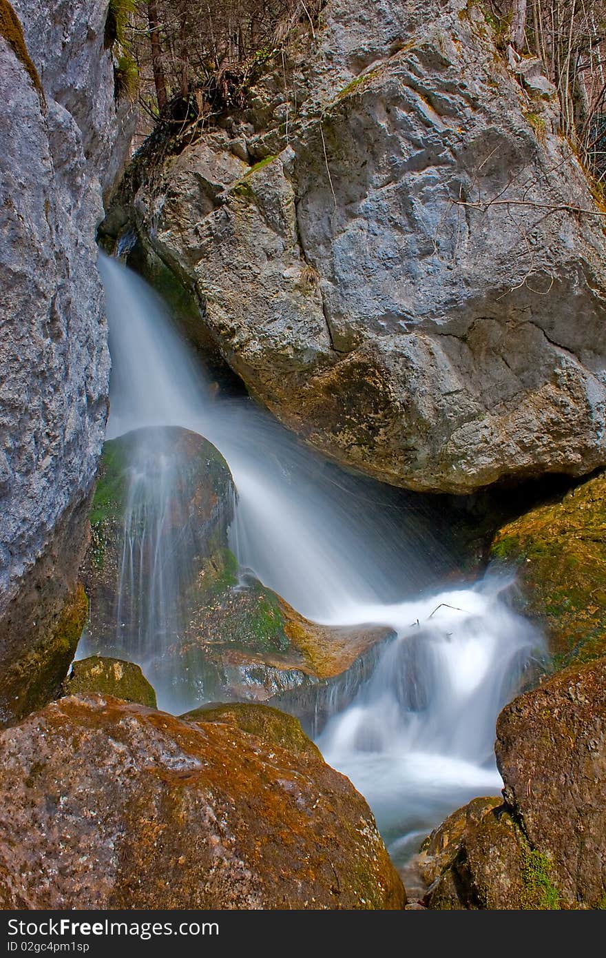 Waterfall on a mountain creek between rocks. Waterfall on a mountain creek between rocks