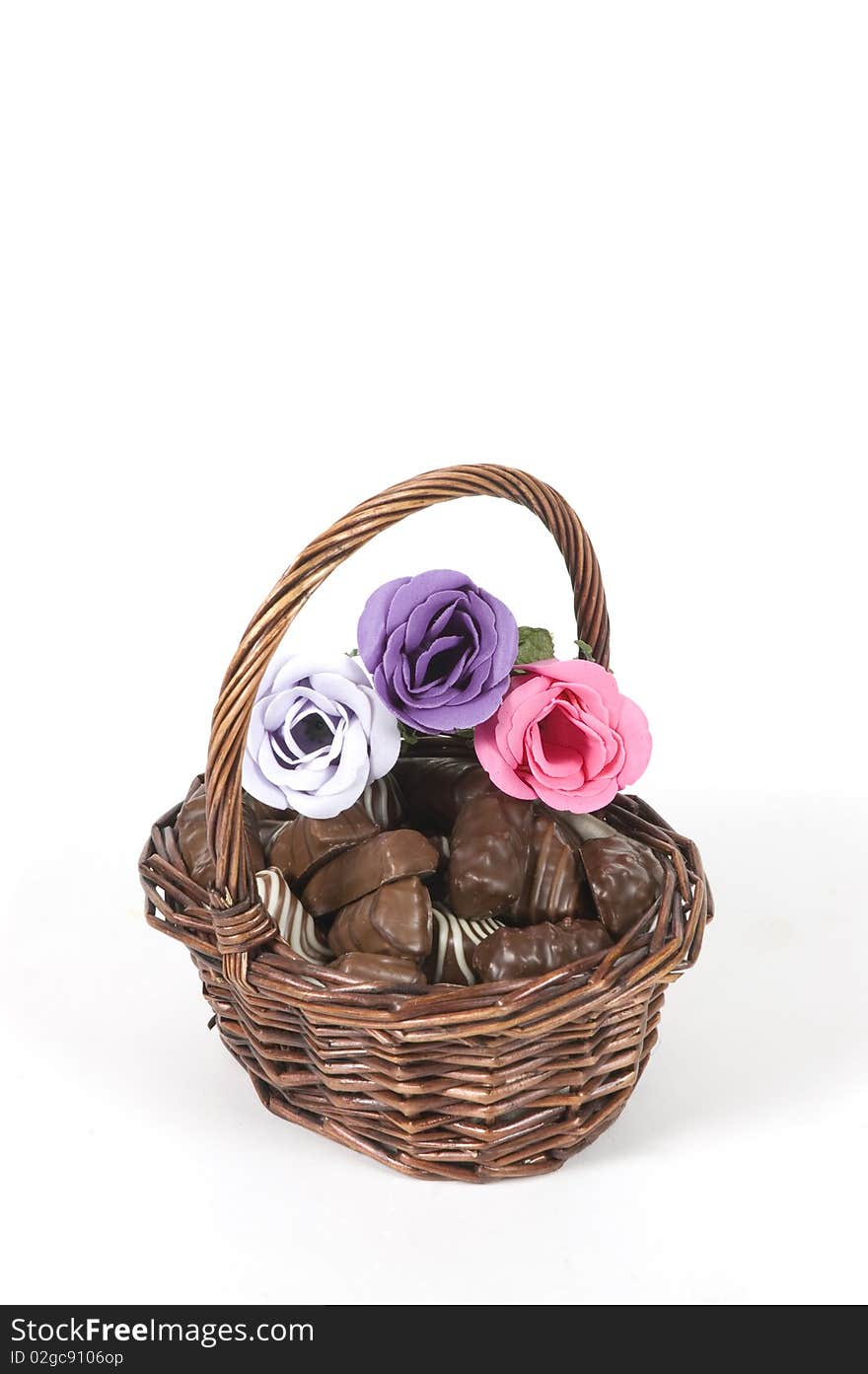 Dark brown basket filled with chocolate and roses