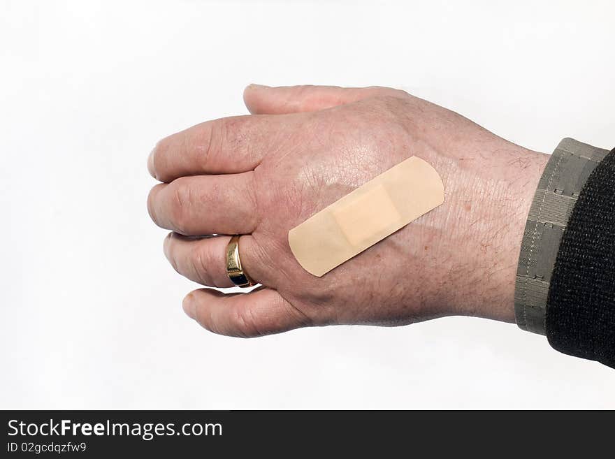 The medical adhesive plaster pasted on a hand of the man. The medical adhesive plaster pasted on a hand of the man