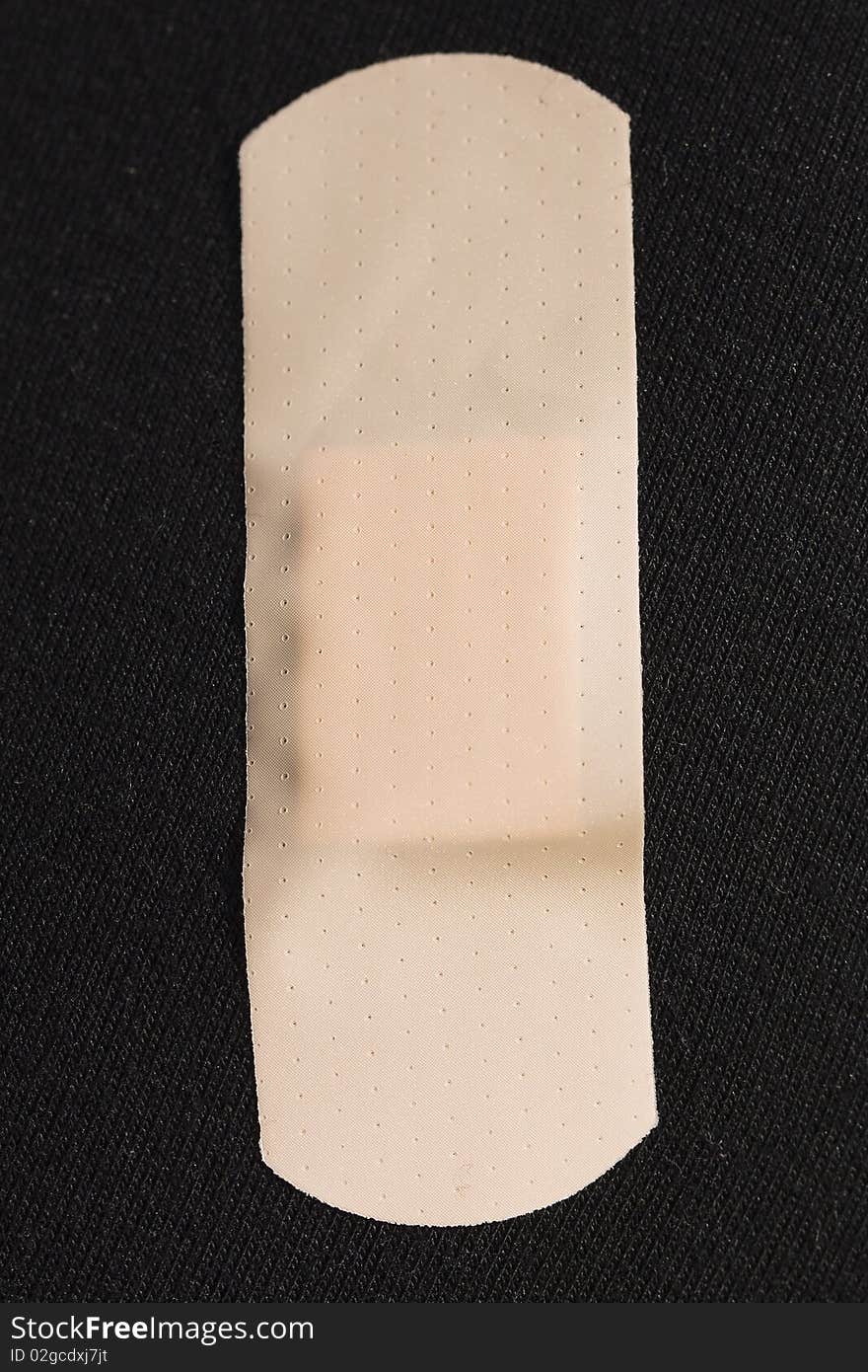 Medical plaster pasted on a black fabric