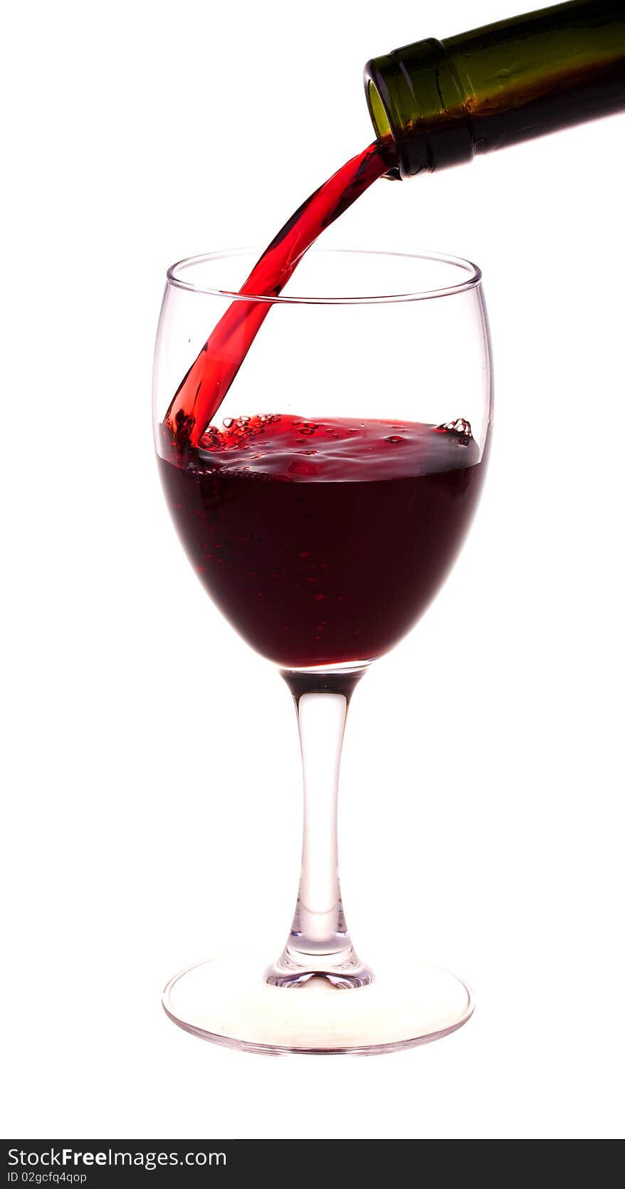 Red wine pouring from a wine bottle isolated on white background