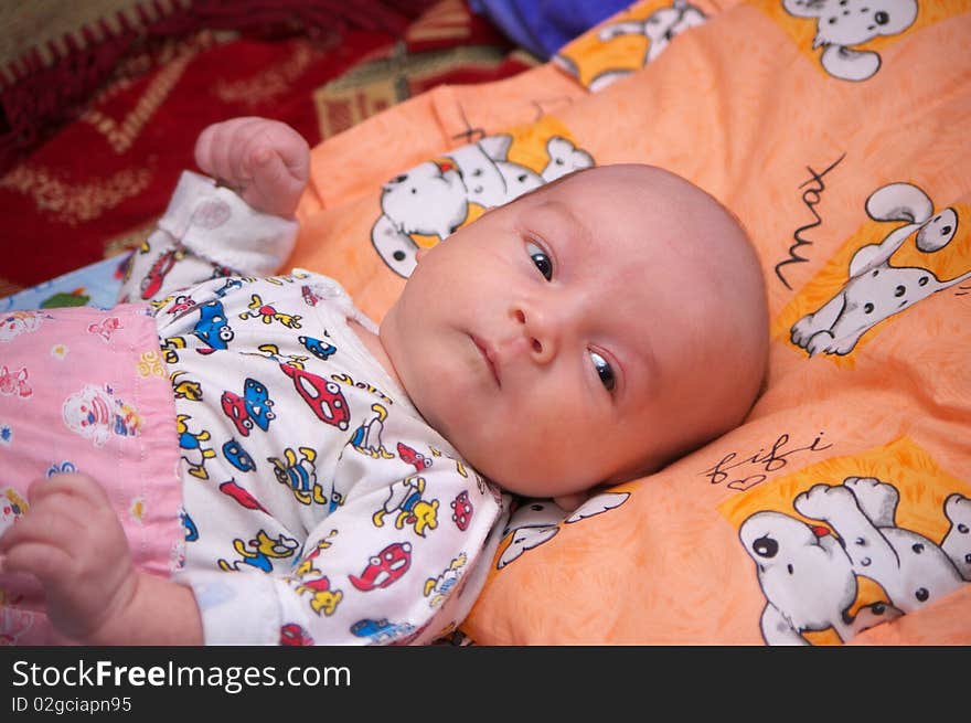 Photo of the beautiful baby lying on bed