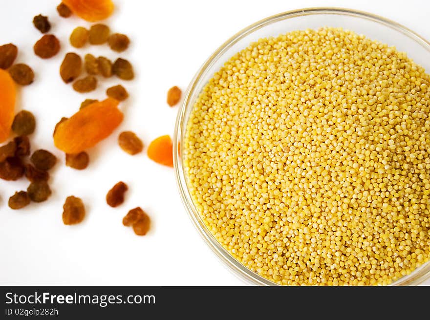 Millet and some dried fruits over white