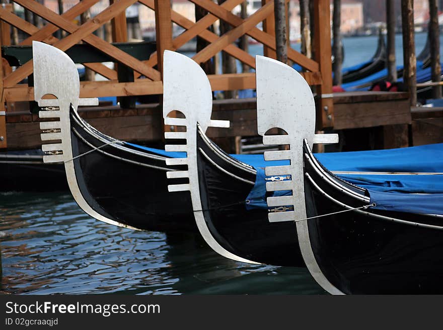 Shining polished metal on moored gondolas. Shining polished metal on moored gondolas