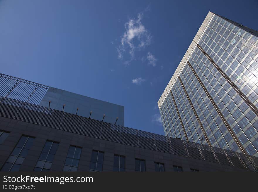 The modern office buildings on blue sky background. The modern office buildings on blue sky background